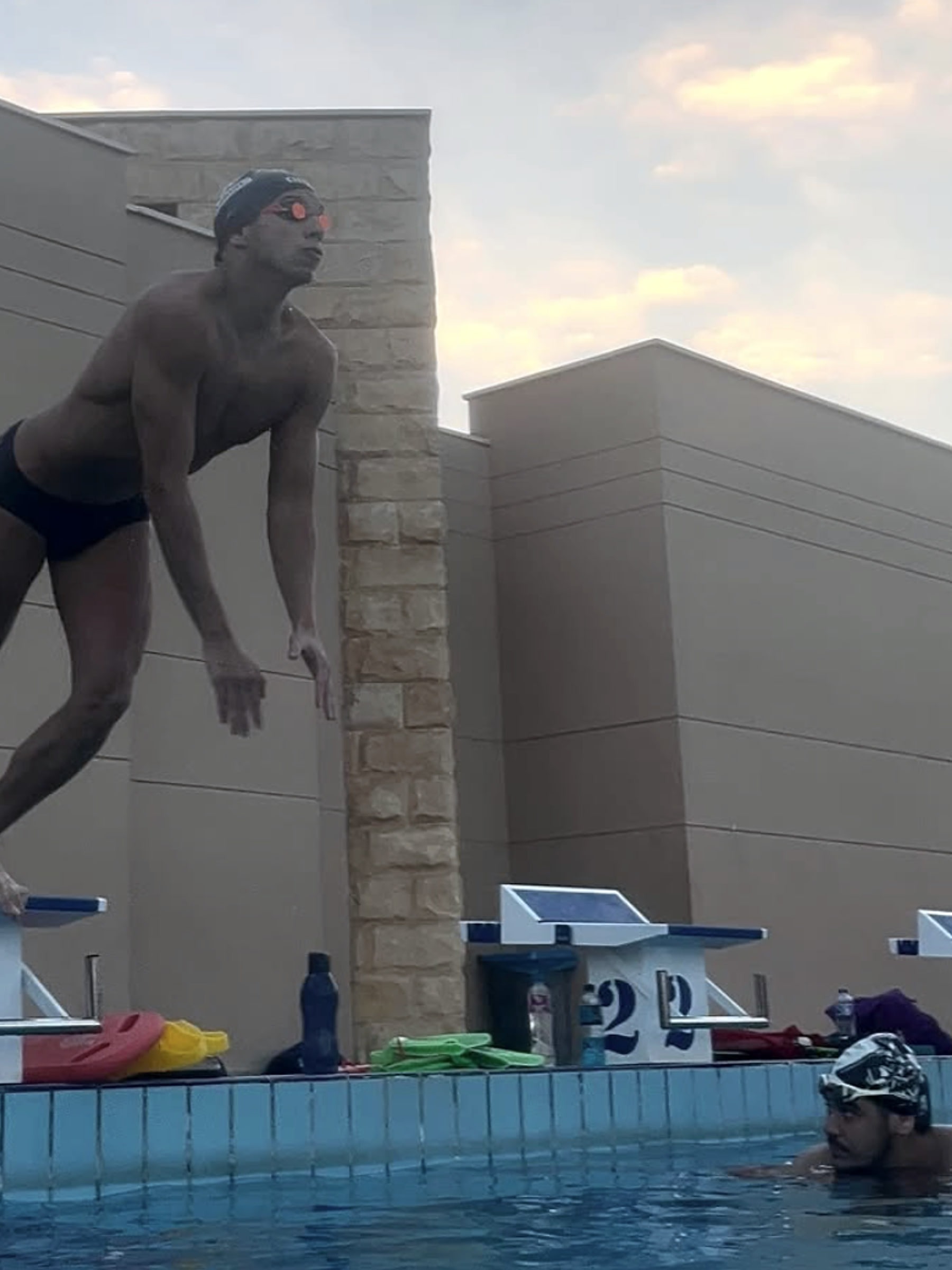 A swimmer in mid-air off the block